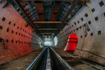 Round tiled tunnel in abandoned underground nuclear physics laboratory