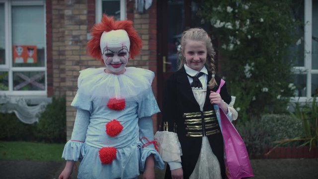 4k Halloween Shot of a Teen Girl and Boy Dressed up in Costumes