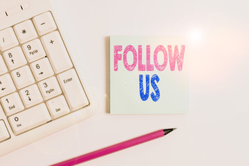 Handwriting text Follow Us. Conceptual photo To invite a demonstrating or group to join his company and take rules White pc keyboard with empty note paper and pencil above white background