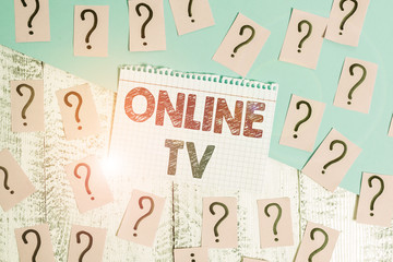 Text sign showing Online Tv. Business photo showcasing a television production broadcast in realtime as events happen Scribbled and crumbling papers with thick cardboard above wooden table
