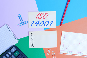 Conceptual hand writing showing Iso 14001. Concept meaning a family of standards related to environmental analysisagement Office appliance square desk study supplies paper sticker