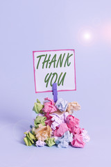 Handwriting text Thank You. Conceptual photo replaying on something good or greetings with pleased way Reminder pile colored crumpled paper clothespin reminder blue background