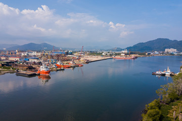 Naklejka na ściany i meble Aerial view of shipyard nearby the main river where the vessels and boats docking.