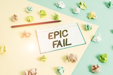 Word writing text Epic Fail. Business photo showcasing a spectacularly embarrassing mistake Humiliating situation Colored crumpled papers empty reminder blue yellow background clothespin