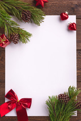 Holiday Christmas card with fir tree and festive decorations balls, stars on wood background. Christmas template for banner, ticket, leaflet, card, invitation, poster