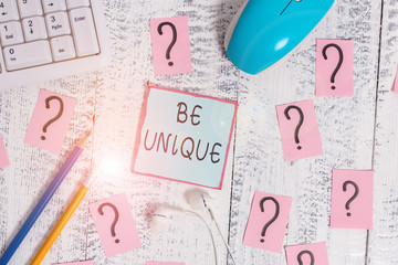 Word writing text Be Unique. Business photo showcasing being the only one of its kind Unlike anything else Incomparable Writing tools, computer stuff and scribbled paper on top of wooden table