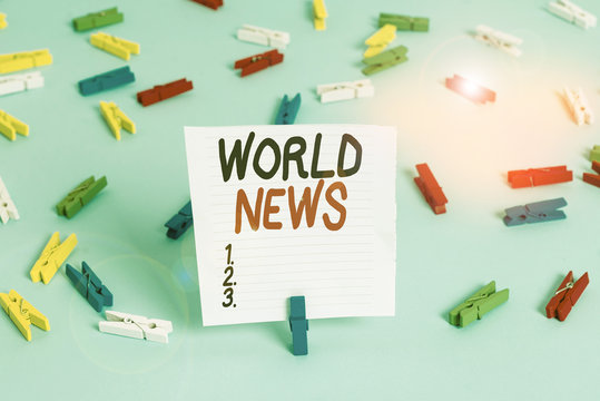 Word writing text World News. Business photo showcasing global noteworthy information about recent or important events Colored clothespin papers empty reminder blue floor background office pin