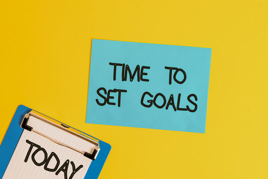 Text sign showing Time To Set Goals. Business photo text Desired Objective Wanted to accomplish in the future Metal clipboard holding blank paper sheet square page colored background