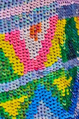 Obraz premium Fabric with sequins and sequins of bright colors. Fashion glitter fabric, sequins. Shiny surface