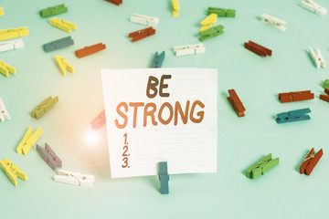 Word writing text Be Strong. Business photo showcasing able to withstand great circumstances or pressure in life Colored clothespin papers empty reminder blue floor background office pin