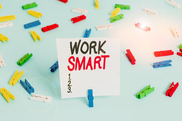 Word writing text Work Smart. Business photo showcasing figuring out in order to reach goals in the most efficient way Colored clothespin papers empty reminder blue floor background office pin