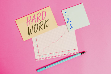 Writing note showing Hard Work. Business concept for always putting a lot of effort and care into work or endurance Stationary and note paper math sheet with diagram picture on the table