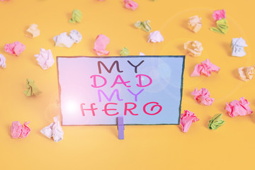 Text sign showing My Dad My Hero. Business photo showcasing Admiration for your father love feelings emotions compliment Colored crumpled papers empty reminder white floor background clothespin