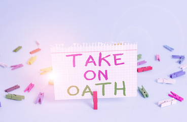 Word writing text Take On Oath. Business photo showcasing A solemn appeal to a deity Speak the truth Make a Promise Colored clothespin rectangle square shaped paper light blue background