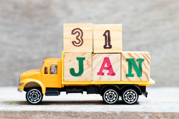Truck hold letter block in word 31jan on wood background (Concept for date 31 month January)