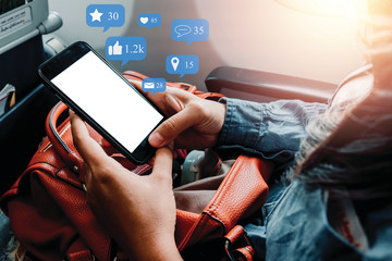 Passenger in plane hand using empty screen smart phone with social icon, Social, media, Marketing concept.