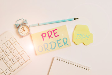 Word writing text Pre Order. Business photo showcasing an order for a product placed before it is available for purchase Copy space on empty note paper with clock and pencil on the table