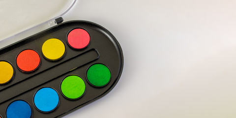 Unused watercolor close-up with copy space. Isolated on white.