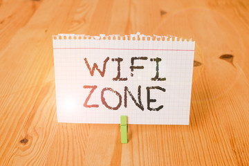 Word writing text Wifi Zone. Business photo showcasing provide wireless highspeed Internet and network connections Empty reminder wooden floor background green clothespin groove slot office