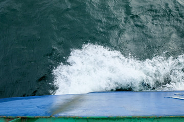 Starboard side of a ferry boat on the South China Sea being hit hard by waves in the evening.