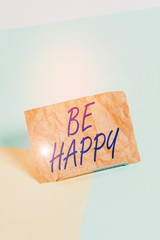 Word writing text Be Happy. Business photo showcasing to live every moment as the last love your life work family Paper placed tilted above buffer wire on soft pastel multi colours backdrop