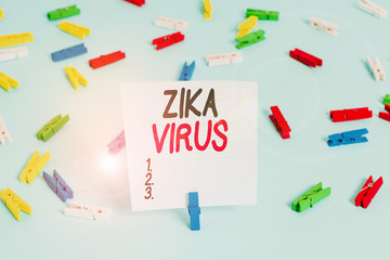 Word writing text Zika Virus. Business photo showcasing caused by a virus transmitted primarily by Aedes mosquitoes Colored clothespin papers empty reminder blue floor background office pin