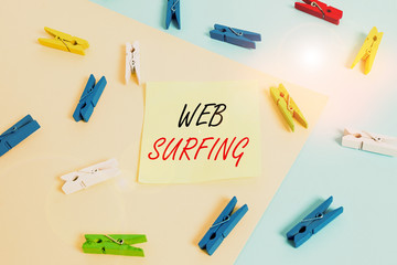 Word writing text Web Surfing. Business photo showcasing Jumping or browsing from page to page on the internet webpage Colored clothespin paper empty reminder yellow blue floor background office