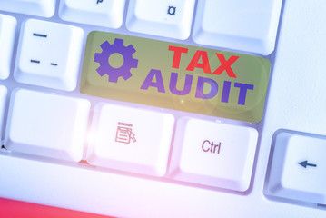 Writing note showing Tax Audit. Business concept for examination or verification of a business or...