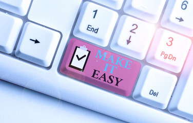 Writing note showing Make It Easy. Business concept for Smart approach Effortless Free from worries or difficulties White pc keyboard with note paper above the white background