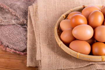 Chicken brown eggs on wicker baskets