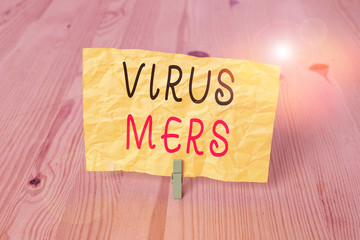 Conceptual hand writing showing Virus Mers. Concept meaning viral respiratory illness that first reported in Saudi Arabia Wooden floor background green clothespin groove slot office