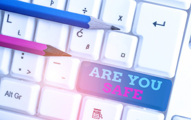 Conceptual hand writing showing Are You Safe. Concept meaning Free from danger Not anticipating any...