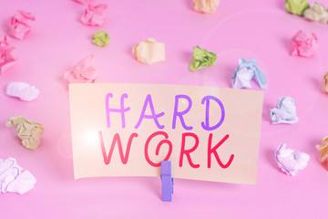 Word writing text Hard Work. Business photo showcasing always putting a lot of effort and care into work or endurance Colored crumpled papers empty reminder pink floor background clothespin