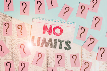 Text sign showing No Limits. Business photo showcasing to do whatever you could with out restrictions and holding back Scribbled and crumbling papers with thick cardboard above wooden table