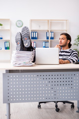 Young employee feeling like prisoner at work