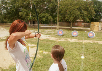Mother and daughter doing archery