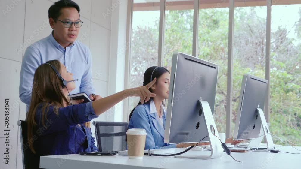 Aufkleber customer support agent or call center with headset works on desktop computer while supporting the cu