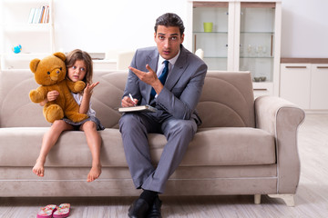Child psychologist attending small girl