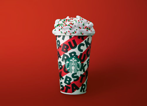 Bangkok, Thailand - November 18, 2019: Starbucks new 2019 designed Christmas holiday cup on the wooden table in the Starbucks coffee shop. Starbucks is the world's largest coffee-house company.