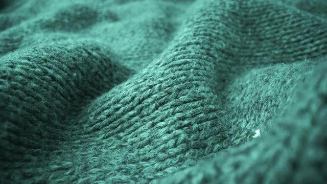 Extreme detail view of sheep wool cloth texture in macro dolly shot. Flowing animal fiber material for handcraft knitting. Textile abstract background. Winter fashion clothing industry concept.