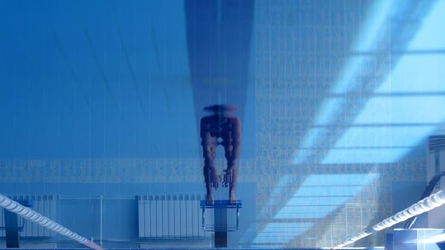 A professional swimmer dives into the pool, picking up a lot of splashes. Slow mo, slo mo, slow motion, high speed camera