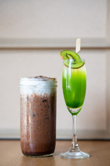Fresh coffee smoothie in a cylindrical glass Place with kiwi fruit juice