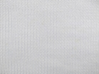 Background of wool yarn for yarn frame. White knitting yarn for handicrafts background. Knitted clothes from wool yarn.