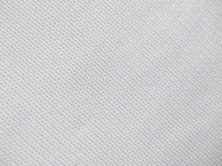 Plakat Background of wool yarn for yarn frame. White knitting yarn for handicrafts background. Knitted clothes from wool yarn.