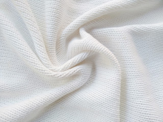 Background of wool yarn for yarn frame. White knitting yarn for handicrafts background. Knitted clothes from wool yarn.