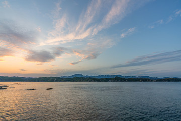 Fototapeta premium beautiful twilight sunset with blue sky high peak mountains mist fog green forest park ocean sea idea for backpacker guiding backpacking camping campfire relax hiking long weekend at Wakayama Japan