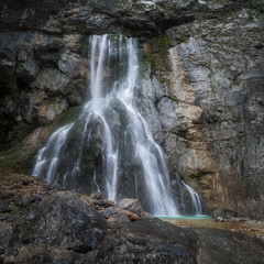 water flows from the waterfall flowing down the rock