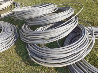 Aluminum electrical power cable on the meadow. Heavy aluminum wire for power supply.