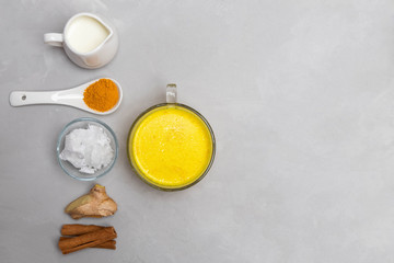 Obraz na płótnie Canvas Ingredients for turmeric golden milk on grey neutral background