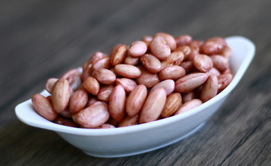 Red kidney bean on wood background.